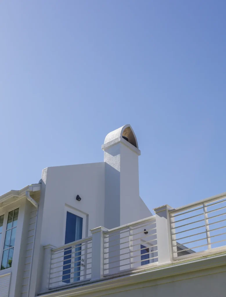 Alesch beach home catwalk exterior architecture fireplace Architectural catwalk porch with rooftop fireplace exterior and panoramic coastal views in luxury beach home design