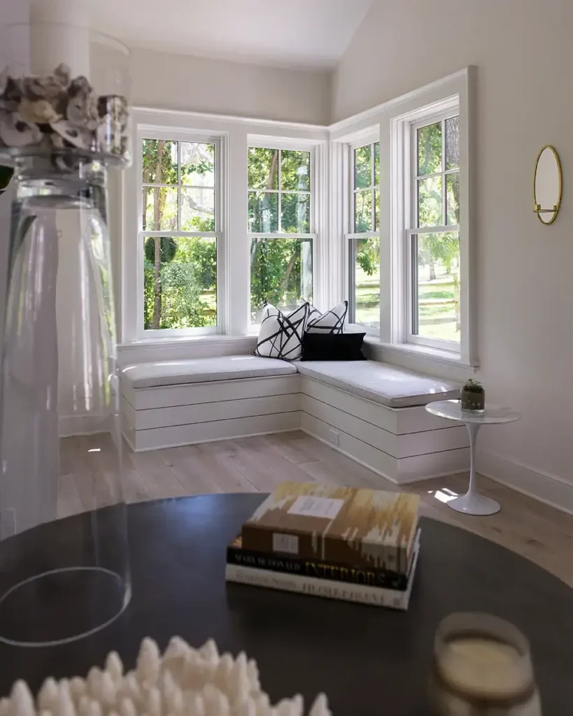 Custom window bench with built-in storage and views of surrounding greenery—part of a North Guana Preserve home remodel by Alesch Luxury Custom Builders.