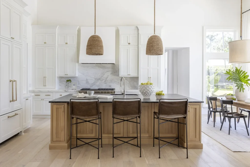 Wide view of custom Ponte Vedra kitchen with marble backsplash, paneled cabinetry, and open-concept layout by Alesch Luxury Custom Builders.