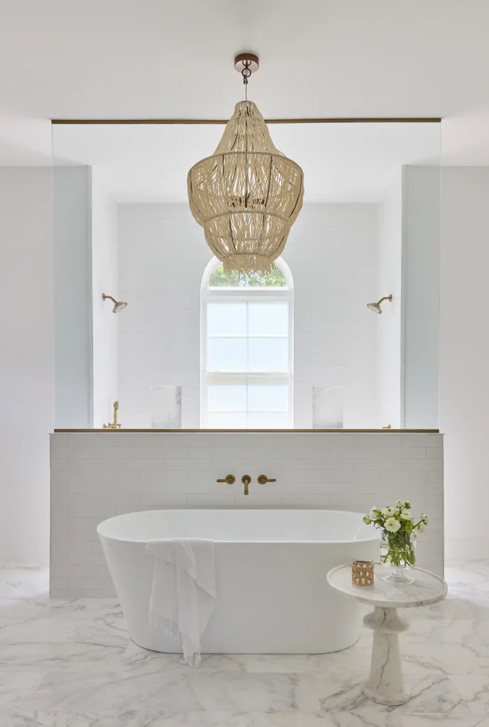 Spa-inspired master bathroom renovation with freestanding tub and modern chandelier in Ponte Vedra Beach Coastal Home Renovation Master Bathroom - Alesch Luxury Custom Builders